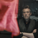 Batman looks at a projection of Superman